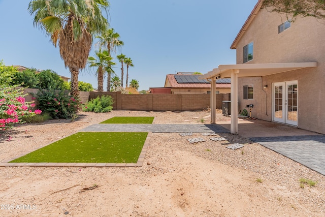 1374 E 10th Pl, Casa Grande, AZ 85122 - fenced backyard with french doors and a patio