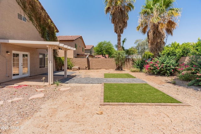 1374 E 10th Pl, Casa Grande, AZ 85122 - fenced backyard featuring french doors and a patio area