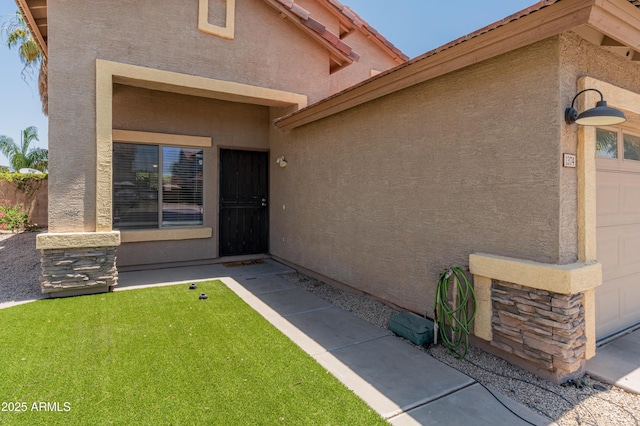 1374 E 10th Pl, Casa Grande, AZ 85122 - doorway to property with stucco siding and an attached garage