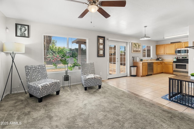 1374 E 10th Pl, Casa Grande, AZ 85122 - living room featuring healthy amount of natural light, ceiling fan, french doors, and light tile patterned floors