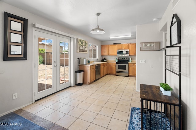 1374 E 10th Pl, Casa Grande, AZ 85122 - kitchen featuring appliances with stainless steel finishes, french doors, light countertops, light tile patterned floors, and hanging light fixtures