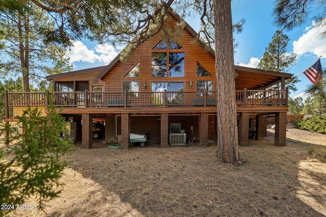 rear view of house with a wooden deck and central AC unit