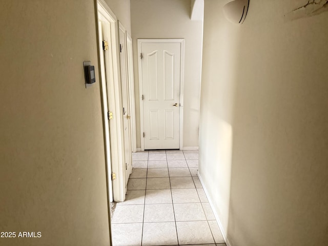 hall featuring light tile patterned floors