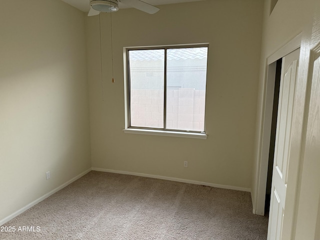 spare room featuring ceiling fan and carpet floors