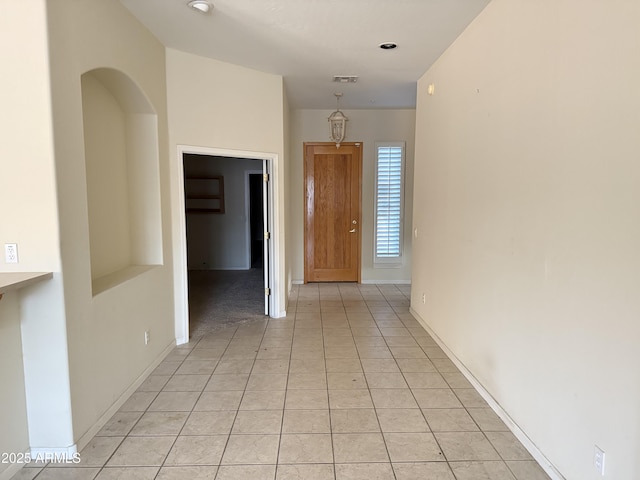 hallway featuring light tile patterned flooring