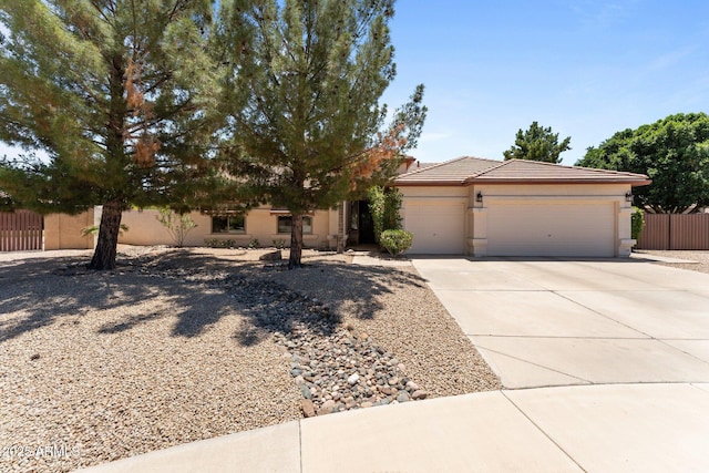 7315 W Monte Lindo Ln, Glendale, AZ 85310 - view of front of property featuring an attached garage, driveway, stucco siding, and a tile roof