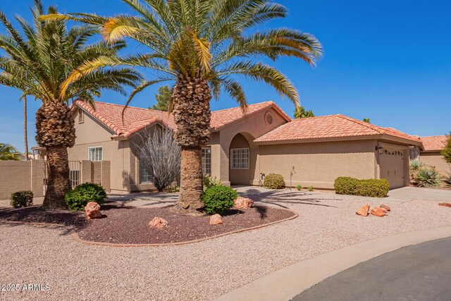 24832 S Boxwood Dr, Sun Lakes, AZ 85248 - view of front of home with a tile roof, stucco siding, concrete driveway, fence, and a garage