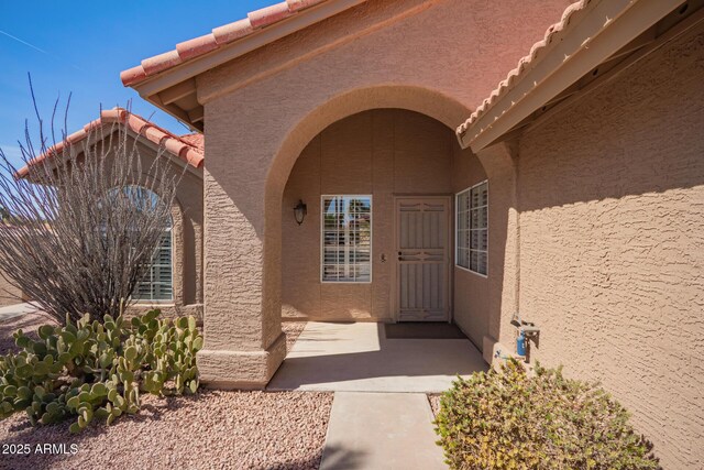 24832 S Boxwood Dr, Sun Lakes, AZ 85248 - view of exterior entry featuring a tiled roof and stucco siding