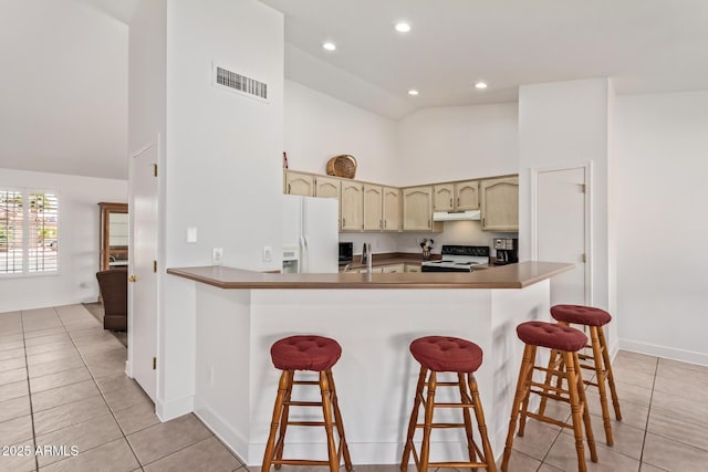 24832 S Boxwood Dr, Sun Lakes, AZ 85248 - kitchen featuring white refrigerator with ice dispenser, visible vents, electric range, under cabinet range hood, and a kitchen bar