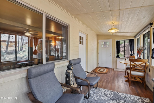 sunroom featuring plenty of natural light and wood ceiling