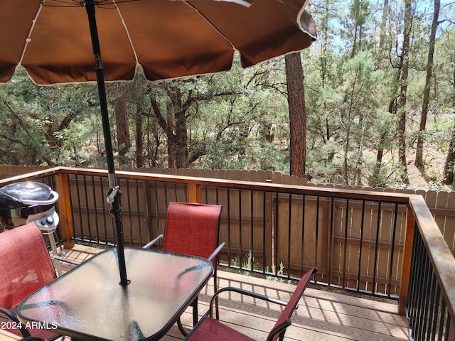 deck with outdoor dining area and a grill