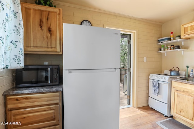 kitchen with ornamental molding, open shelves, white appliances, and dark countertops