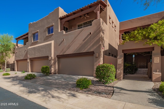 13600 N Fountain Hills Blvd Unit 501, Fountain Hills, AZ 85268 - pueblo revival-style home featuring an attached garage, stucco siding, driveway, and a balcony
