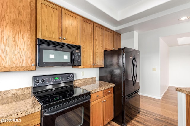 13600 N Fountain Hills Blvd Unit 501, Fountain Hills, AZ 85268 - kitchen featuring black appliances, light wood-style flooring, brown cabinetry, recessed lighting, and tile countertops