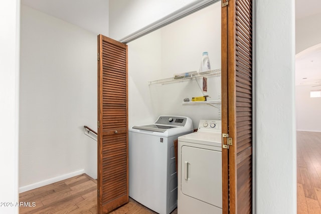 13600 N Fountain Hills Blvd Unit 501, Fountain Hills, AZ 85268 - laundry room featuring separate washer and dryer, light wood-style flooring, and arched walkways