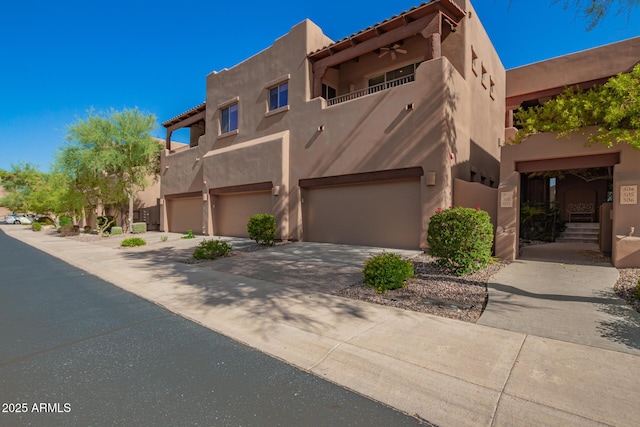 13600 N Fountain Hills Blvd Unit 501, Fountain Hills, AZ 85268 - pueblo revival-style home with a garage, stucco siding, and concrete driveway