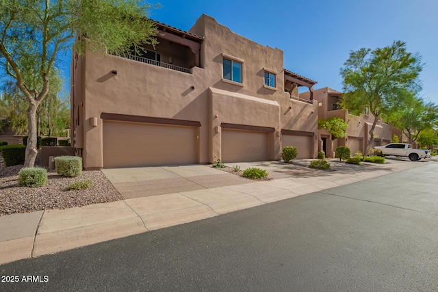 13600 N Fountain Hills Blvd Unit 501, Fountain Hills, AZ 85268 - southwest-style home featuring a balcony, stucco siding, an attached garage, and concrete driveway