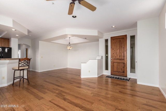 13600 N Fountain Hills Blvd Unit 501, Fountain Hills, AZ 85268 - unfurnished living room featuring arched walkways, wood finished floors, ceiling fan, and recessed lighting