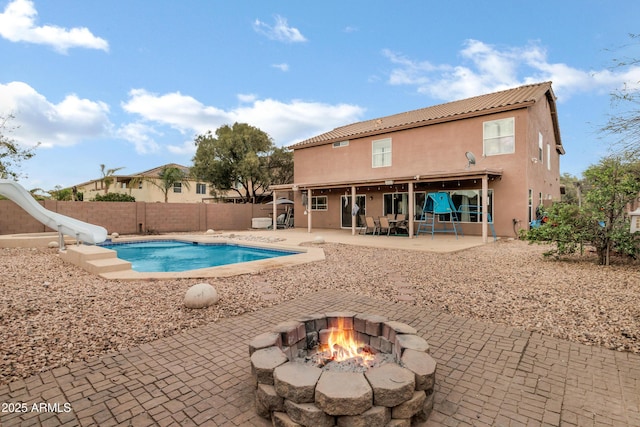 28014 N Jade St, San Tan Valley, AZ 85143 - view of swimming pool with a fenced in pool, an outdoor fire pit, a water slide, a fenced backyard, and a patio