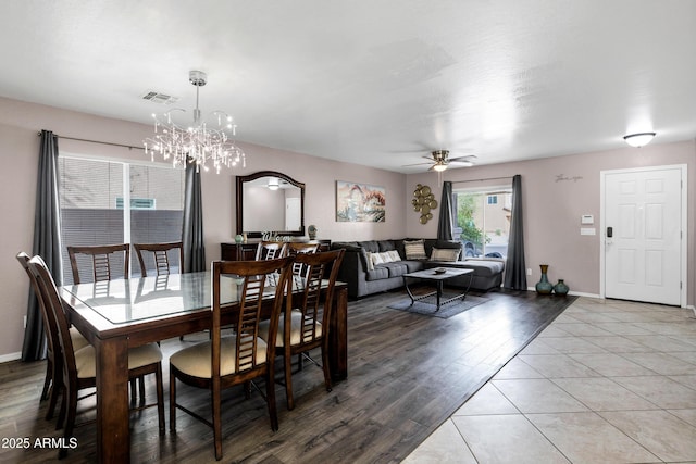 28014 N Jade St, San Tan Valley, AZ 85143 - dining area with baseboards, visible vents, light wood-style floors, and ceiling fan with notable chandelier