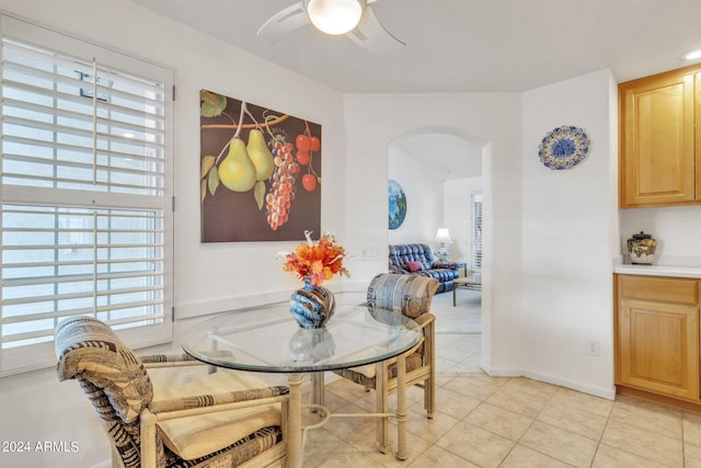 dining space with ceiling fan and light tile patterned floors