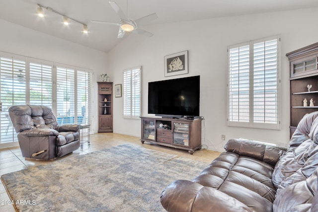 living room featuring ceiling fan, vaulted ceiling, and light tile patterned floors