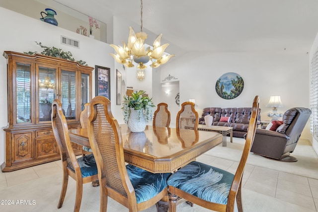 tiled dining room with a notable chandelier and vaulted ceiling