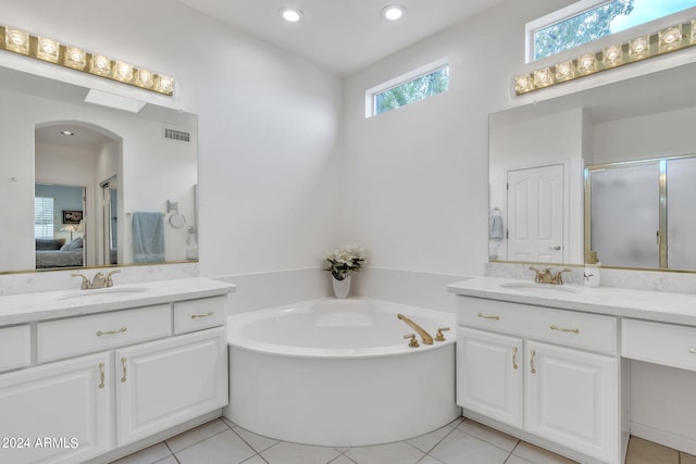 bathroom featuring vanity, shower with separate bathtub, and tile patterned flooring