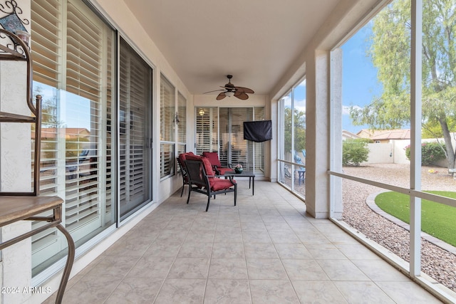 sunroom / solarium featuring ceiling fan