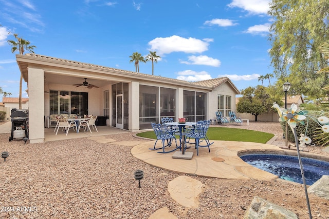 back of property featuring a patio, a sunroom, and ceiling fan