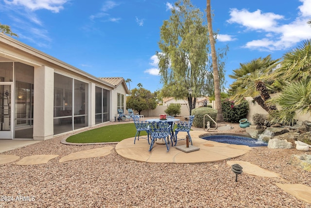 view of patio / terrace featuring a sunroom