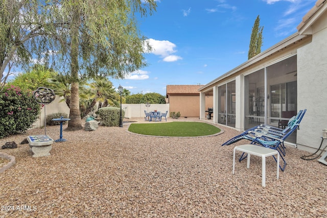 view of yard featuring a patio and a sunroom