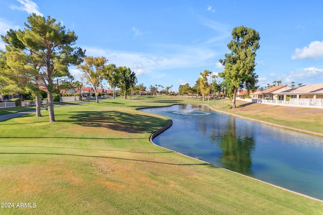 view of property's community featuring a water view and a lawn