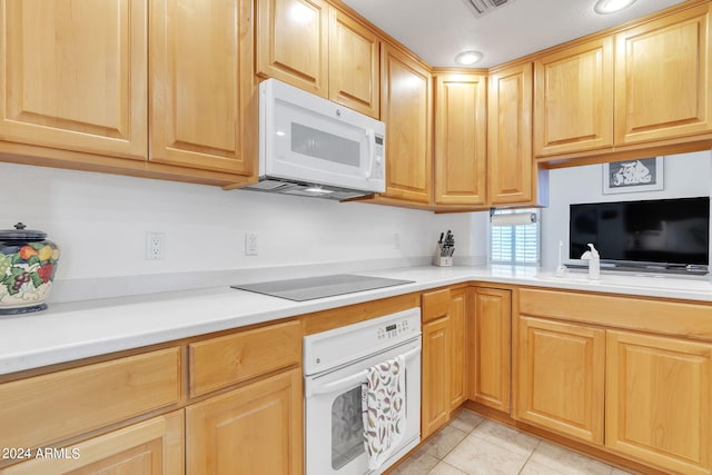 kitchen featuring white appliances and light tile patterned floors