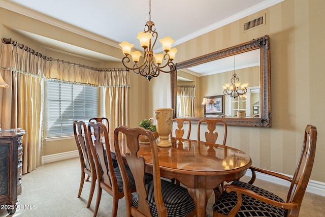 dining space with light colored carpet, ornamental molding, and a chandelier