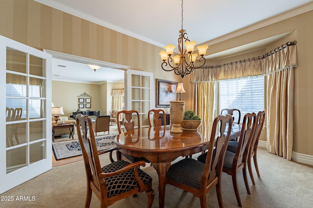 dining room featuring a notable chandelier, crown molding, and light colored carpet