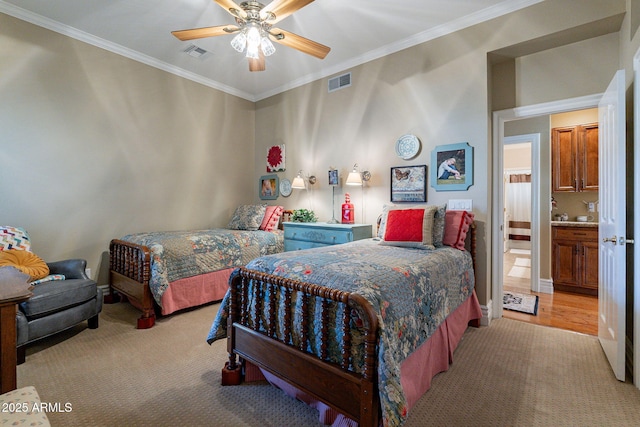 carpeted bedroom with ornamental molding and ceiling fan