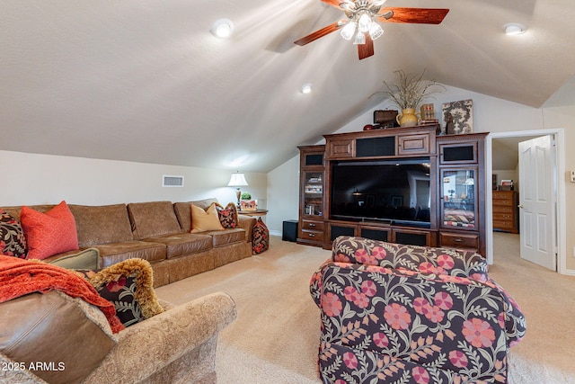 living room featuring vaulted ceiling, light carpet, and ceiling fan