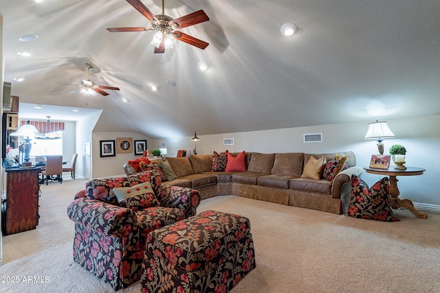 carpeted living room featuring lofted ceiling