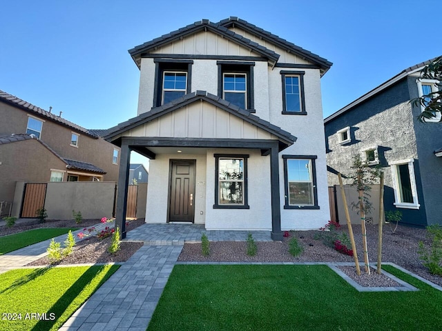 view of front of house with a porch and a front yard