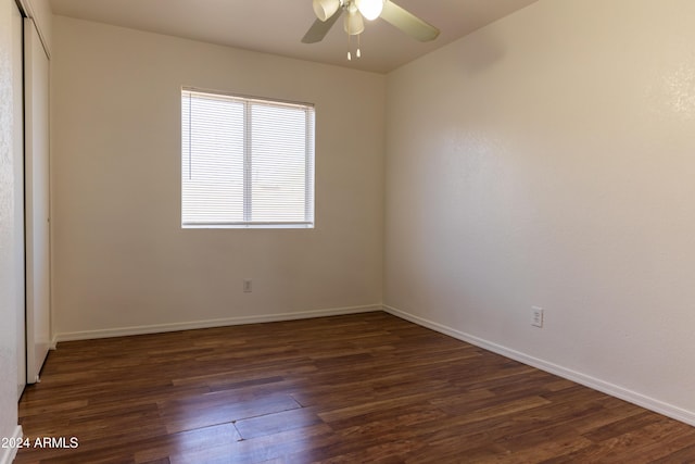 spare room with ceiling fan and dark hardwood / wood-style floors