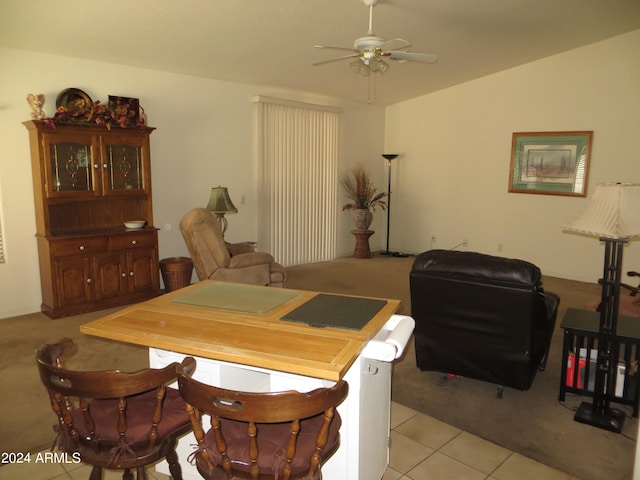 tiled dining room featuring ceiling fan