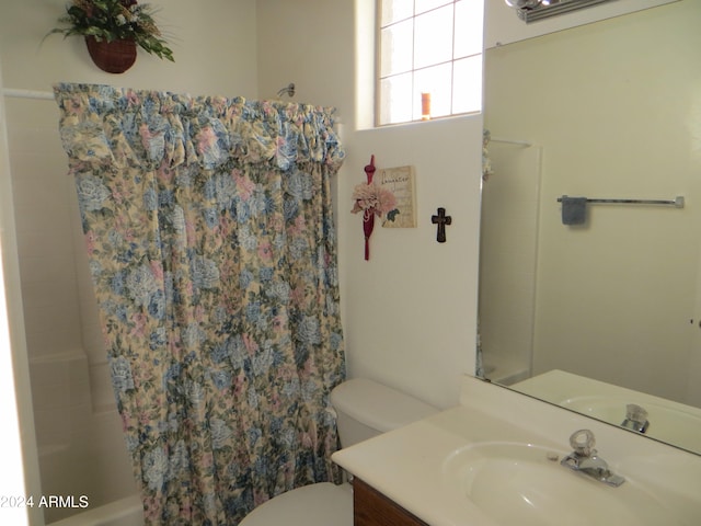 full bathroom featuring vanity, toilet, and shower / tub combo