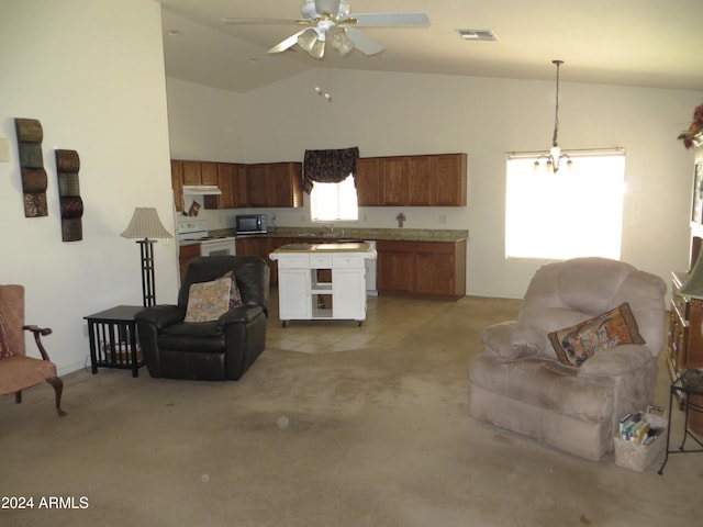 kitchen with white range oven, sink, light colored carpet, pendant lighting, and ceiling fan with notable chandelier