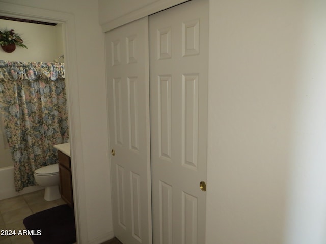 full bathroom with toilet, shower / bath combo with shower curtain, vanity, and tile patterned flooring