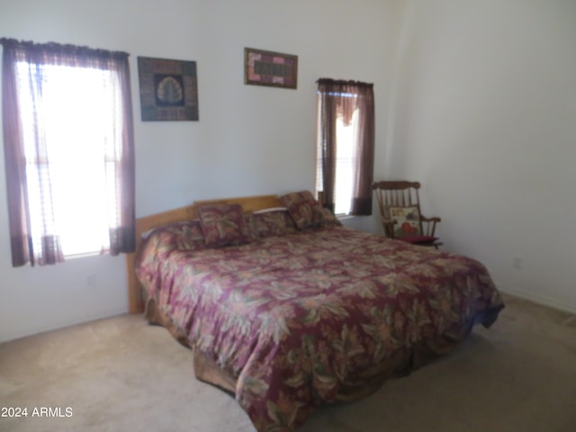 bedroom featuring light carpet