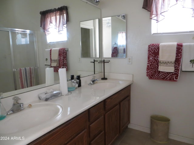 bathroom featuring vanity and an enclosed shower