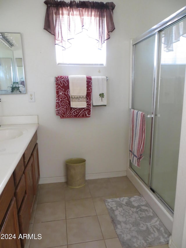 bathroom featuring vanity, tile patterned flooring, and a shower with door