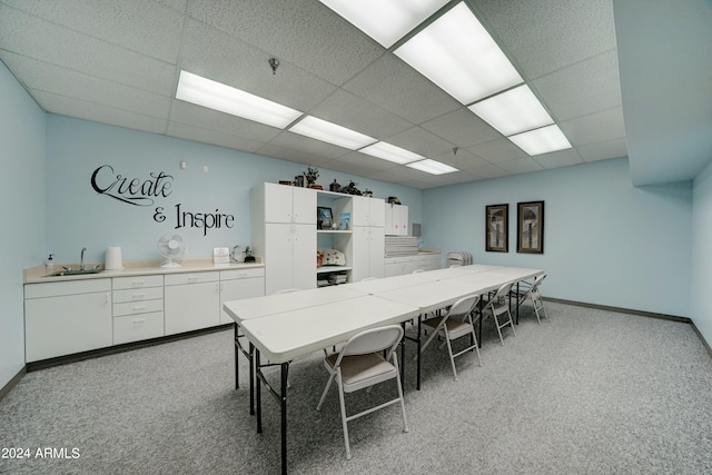 dining room with a paneled ceiling and carpet