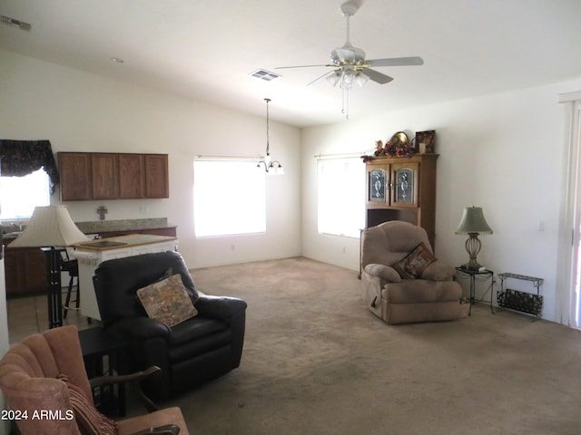 carpeted living room with ceiling fan, a healthy amount of sunlight, and vaulted ceiling